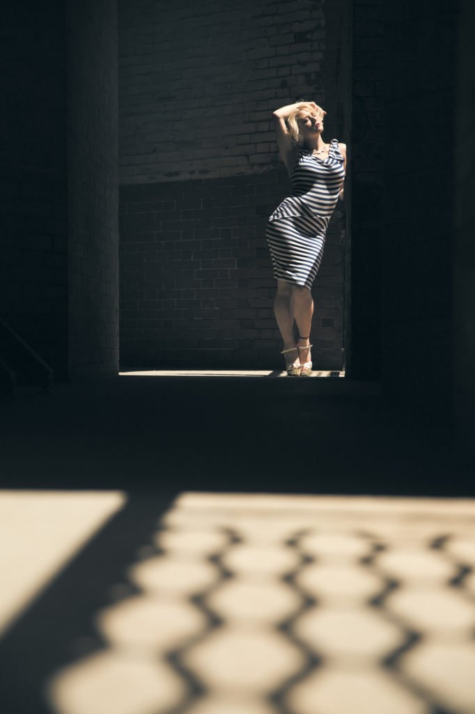 Woman standing in shadows at Fort Point in San Francisco