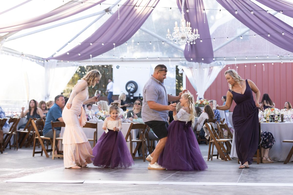 Sonoma candid wedding photographer captures kids and adults dancing at a celebration.